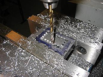  Having drilled all the outside hold-down holes in the chest, I drill pilot holes on the inside to quickly remove material.